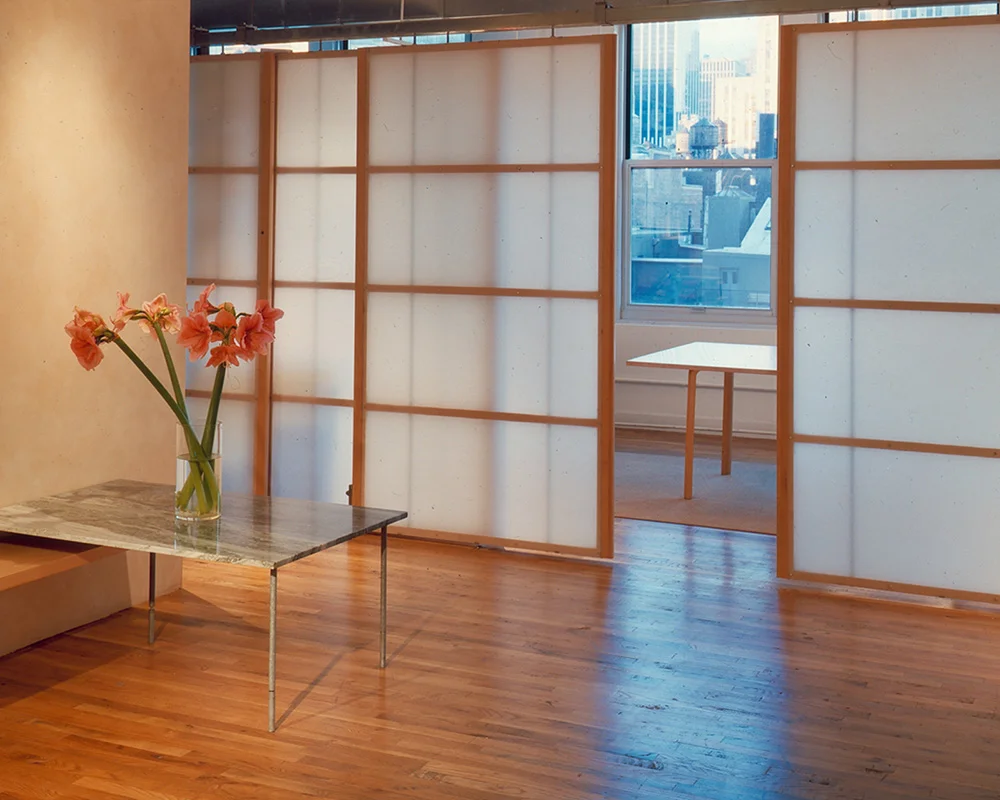 A room with wooden floors and white walls.