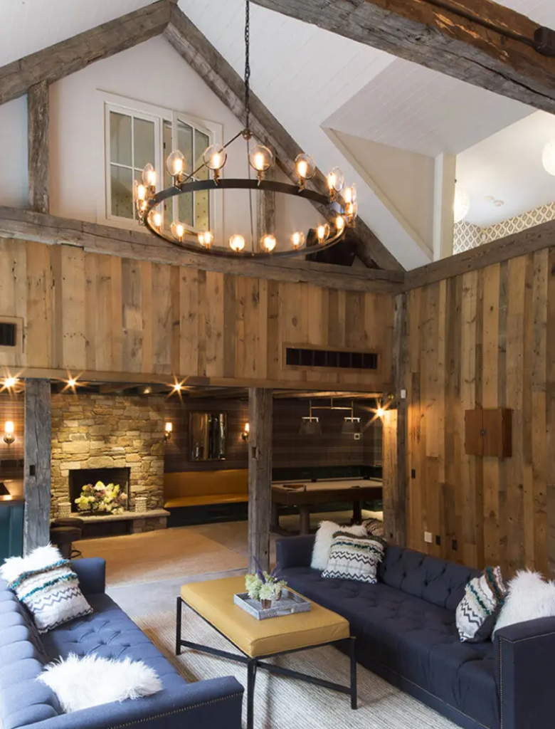 A living room with wood paneled walls and ceiling.