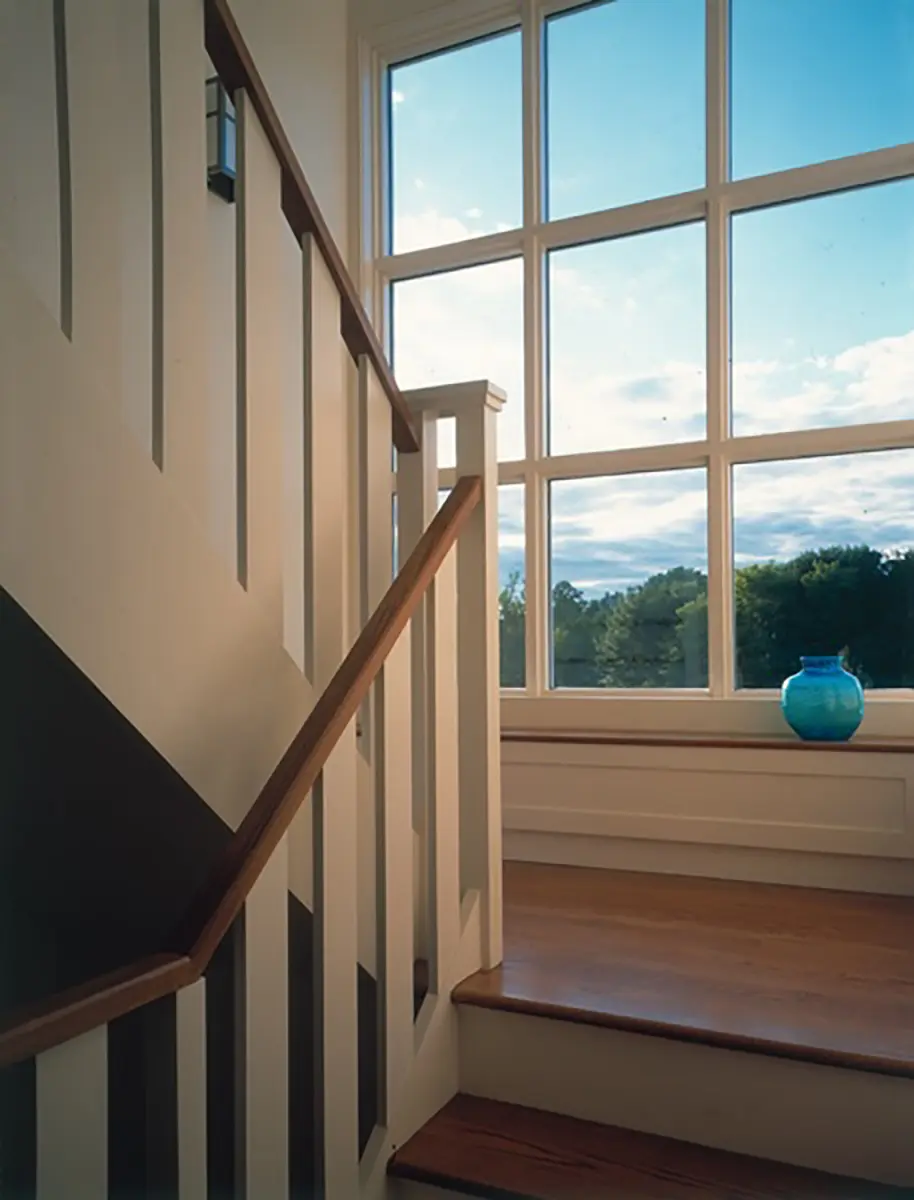 A blue vase sitting on the steps of a staircase.