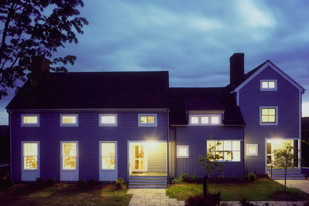 A house with lights on at night.