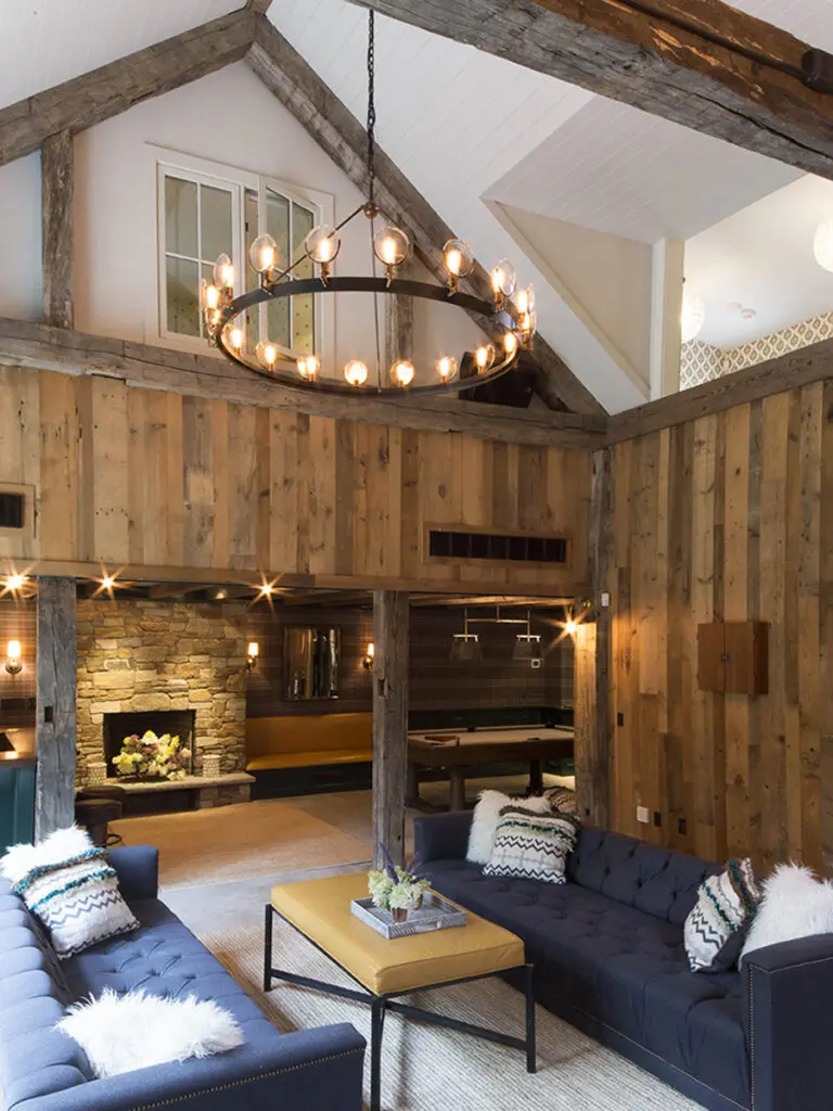 A living room with wood paneled walls and ceiling.