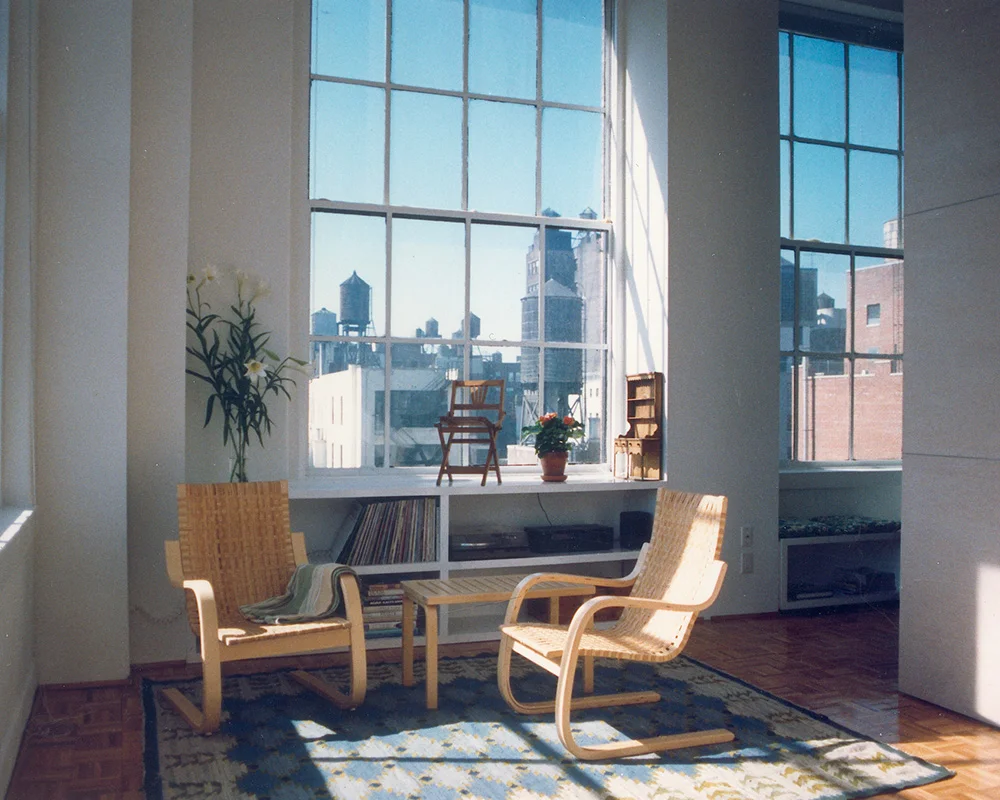 A living room with two chairs and a table